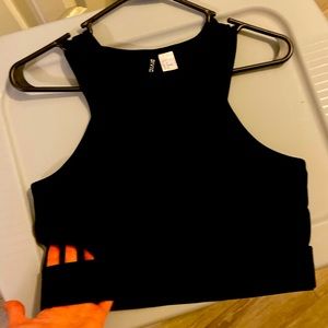 Crop top with side cut outs .